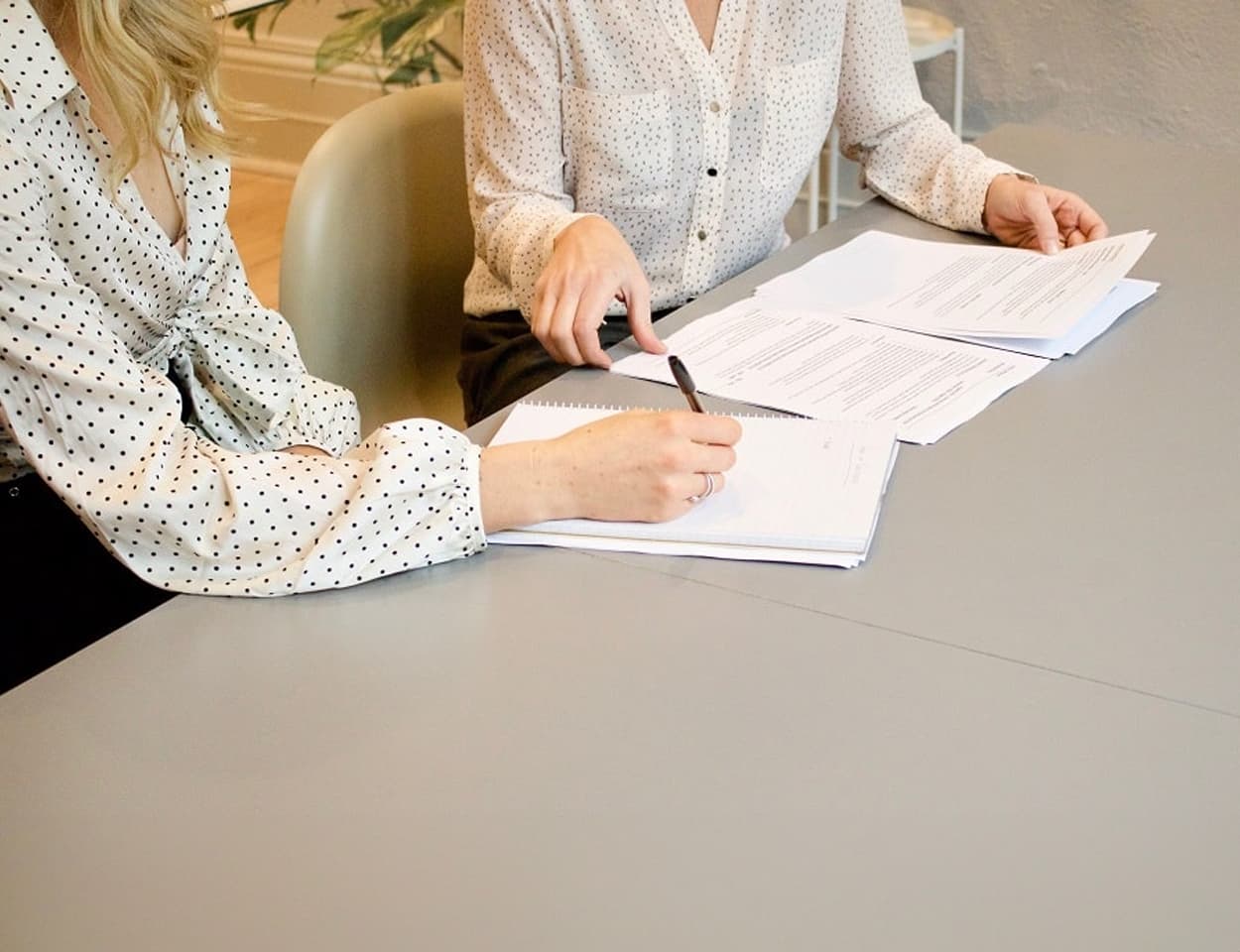 People looking at paperwork on desk